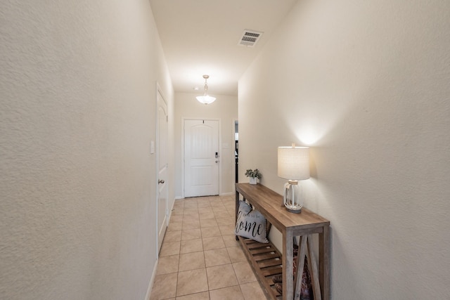 entryway featuring light tile patterned floors and visible vents