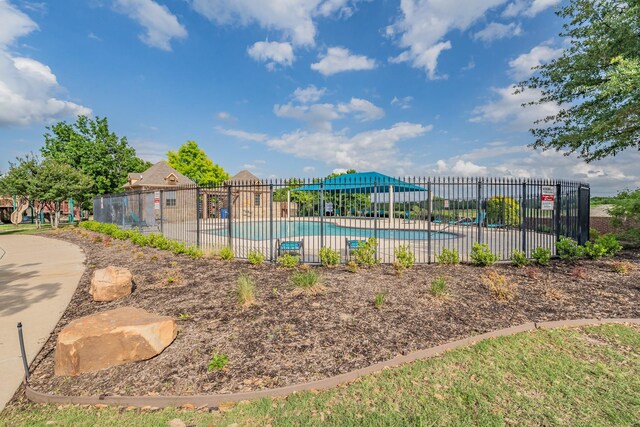 community pool featuring fence