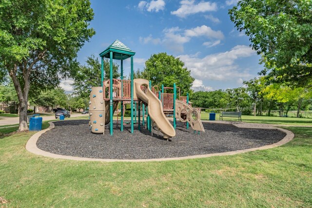 communal playground featuring a yard