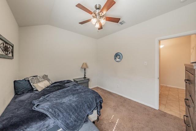 carpeted bedroom featuring visible vents, a ceiling fan, baseboards, and lofted ceiling