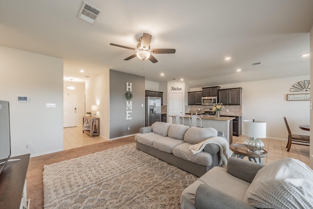 living area with visible vents, recessed lighting, ceiling fan, and light tile patterned floors
