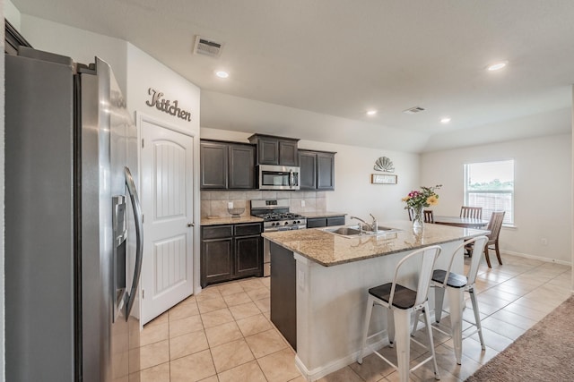 kitchen featuring light tile patterned floors, appliances with stainless steel finishes, a sink, and visible vents