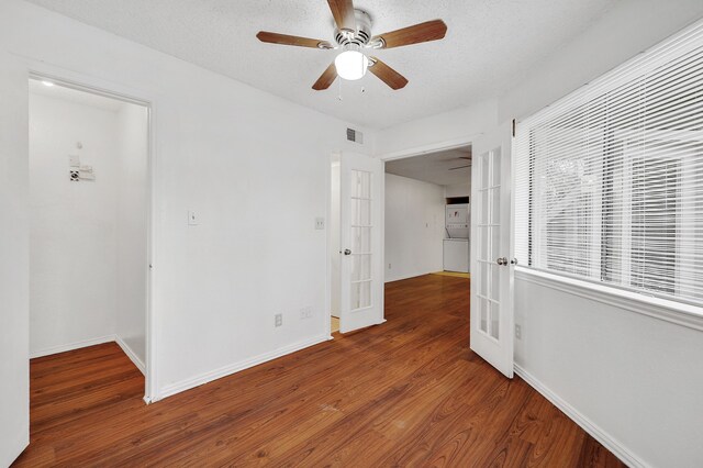 spare room featuring baseboards, french doors, wood finished floors, and visible vents