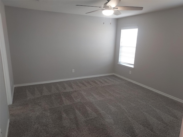 empty room with a ceiling fan, baseboards, and carpet