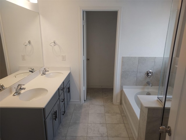 bathroom with a bath, a sink, and tile patterned flooring
