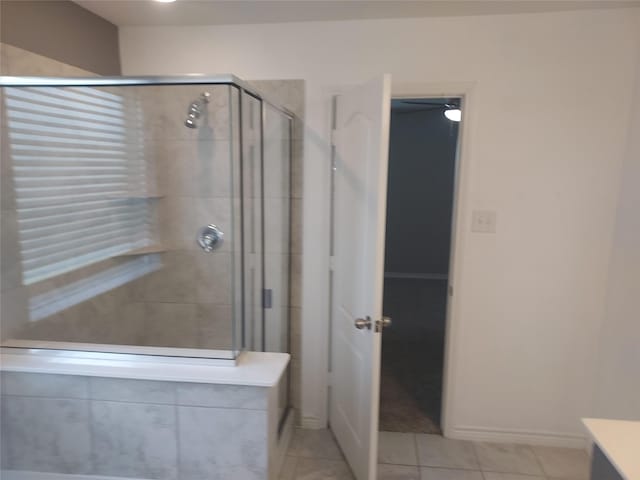 bathroom with tile patterned flooring and a shower stall