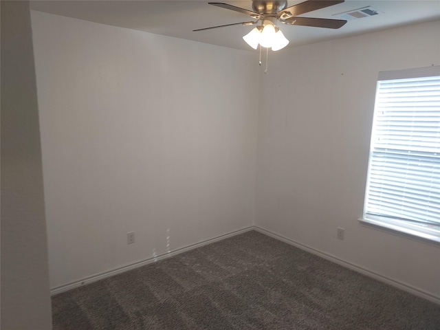 carpeted empty room with ceiling fan, visible vents, and a healthy amount of sunlight