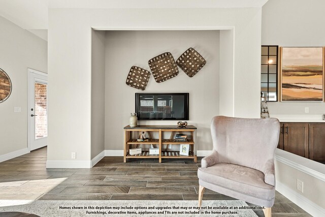 living area with wood finish floors and baseboards