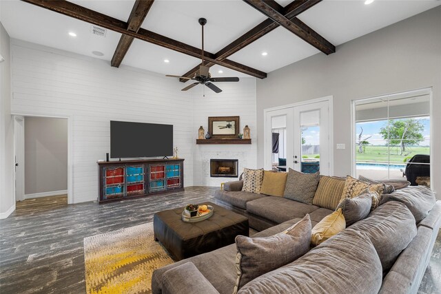 living area with beamed ceiling, coffered ceiling, recessed lighting, and wood finished floors