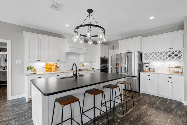 kitchen featuring white cabinets, backsplash, stainless steel appliances, and dark wood-style floors