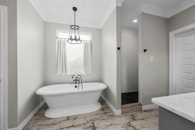 full bath with crown molding, a freestanding tub, an inviting chandelier, and tiled shower