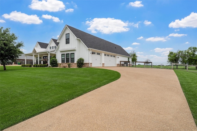 view of front facade featuring fence, roof with shingles, board and batten siding, a front yard, and driveway