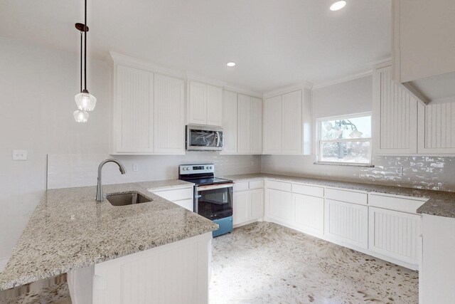 kitchen with a sink, light stone countertops, stainless steel appliances, and a peninsula