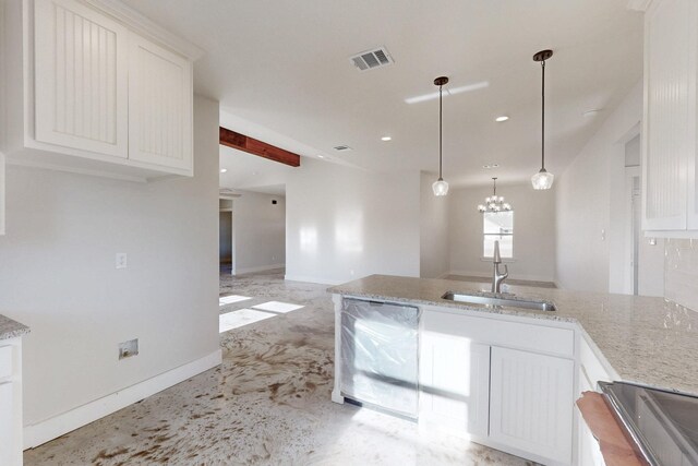 kitchen featuring visible vents, light stone countertops, recessed lighting, white cabinets, and a sink