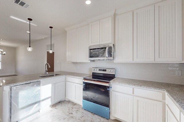 kitchen featuring visible vents, a peninsula, white cabinetry, a sink, and appliances with stainless steel finishes
