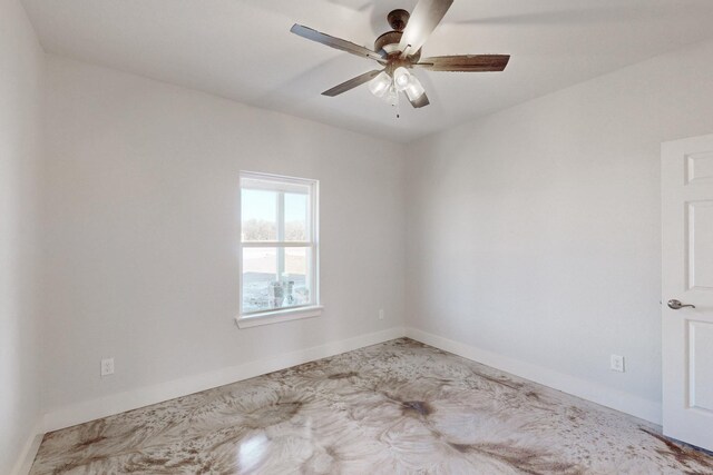 unfurnished room featuring baseboards and a ceiling fan