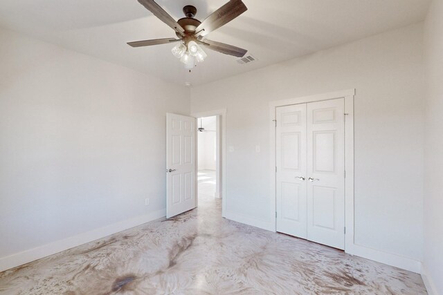 unfurnished bedroom with baseboards, a ceiling fan, a closet, and visible vents