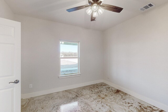 spare room featuring a ceiling fan, baseboards, and visible vents