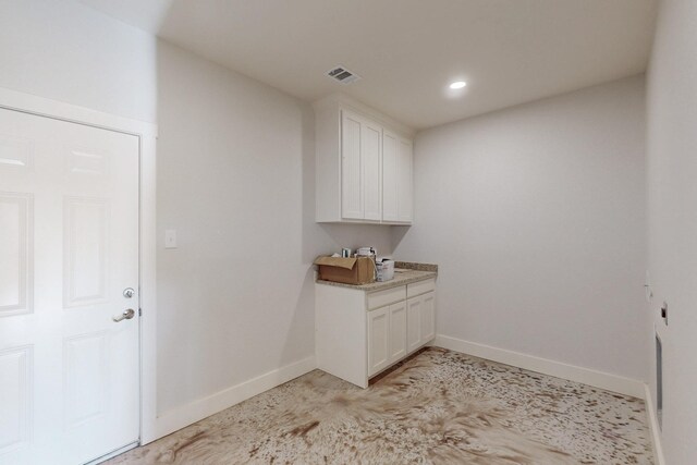 clothes washing area featuring baseboards, recessed lighting, and visible vents