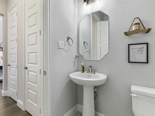 3222 Roy Alton, Melissa, TX 75454 - bathroom with toilet, baseboards, a sink, and wood finished floors