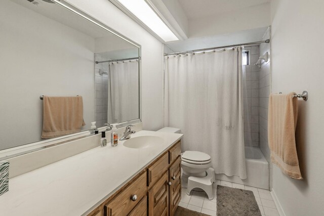 bathroom featuring vanity, shower / tub combo with curtain, tile patterned floors, and toilet
