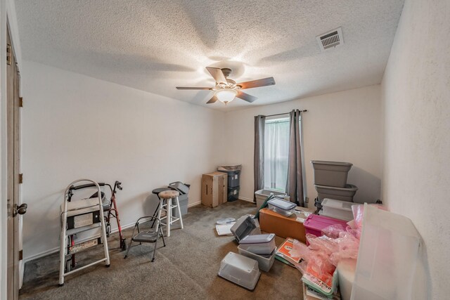 miscellaneous room featuring carpet floors, a textured ceiling, ceiling fan, and visible vents