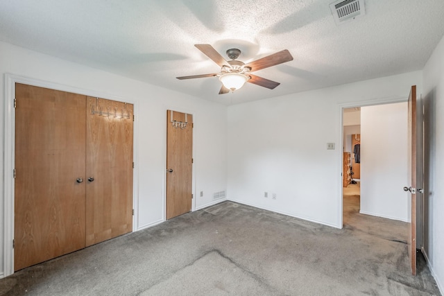 unfurnished bedroom with visible vents, carpet flooring, and ceiling fan