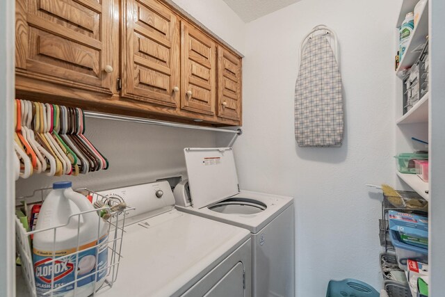 washroom with cabinet space and washing machine and dryer