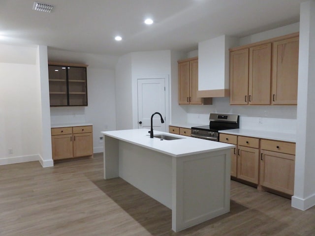 kitchen featuring stainless steel electric range oven, light brown cabinetry, visible vents, and a sink