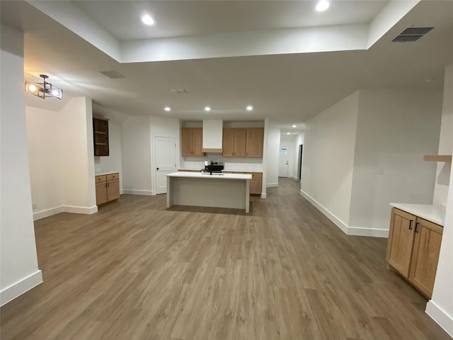 kitchen featuring visible vents, baseboards, stainless steel range oven, and wood finished floors