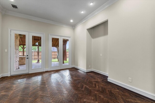 spare room with french doors, baseboards, crown molding, and visible vents