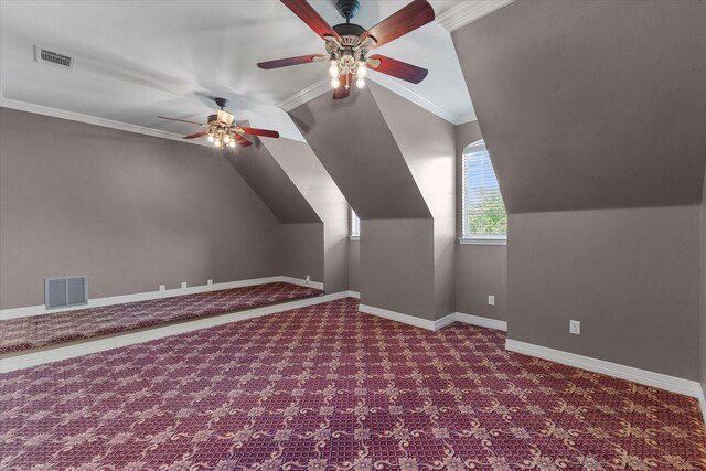 additional living space featuring visible vents, carpet, ceiling fan, and vaulted ceiling