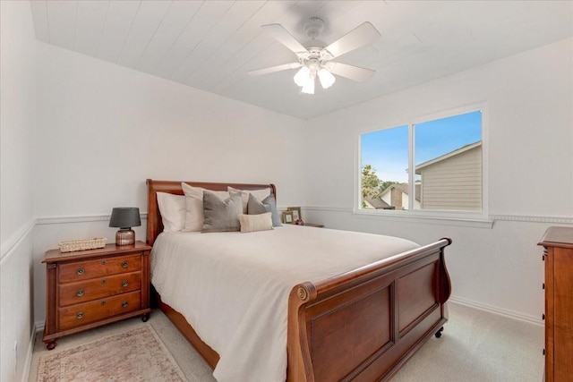 bedroom featuring baseboards, ceiling fan, and light colored carpet