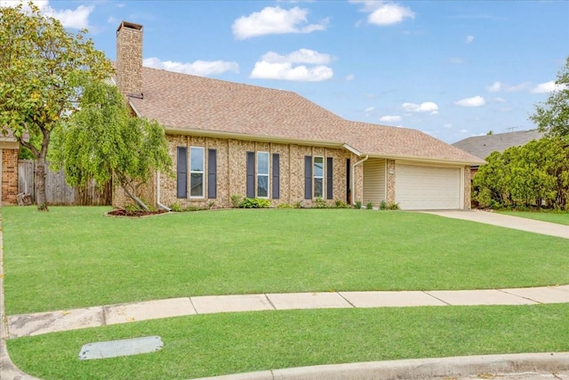 view of front facade with a garage, a front yard, a chimney, brick siding, and concrete driveway