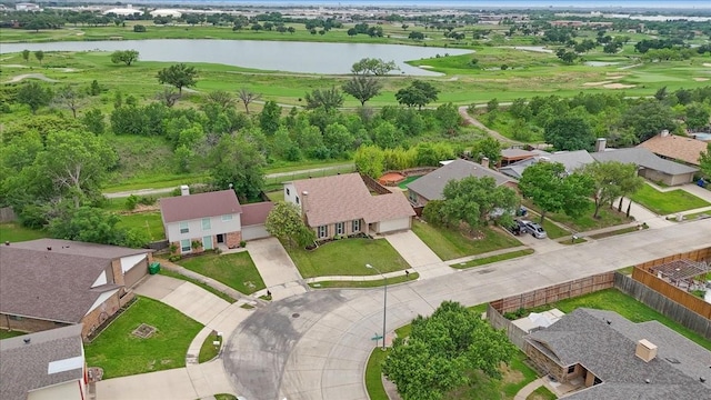 drone / aerial view with a water view, view of golf course, and a residential view