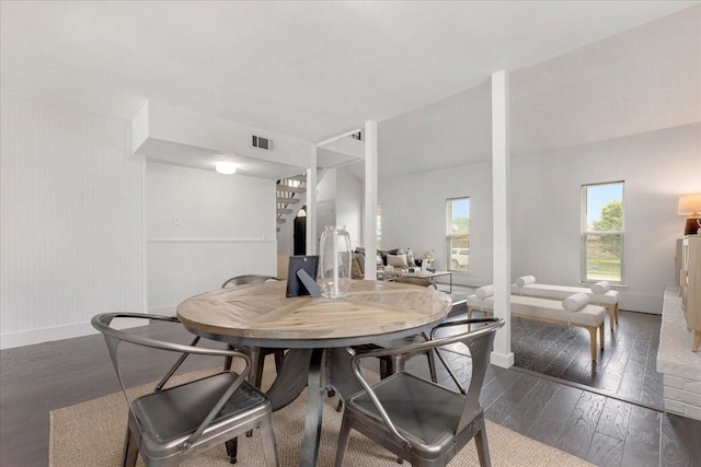 dining room featuring baseboards, wainscoting, hardwood / wood-style flooring, and visible vents