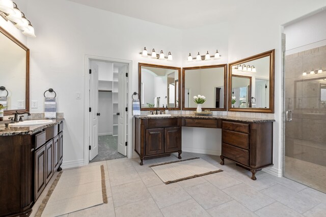bathroom with a sink, a stall shower, and two vanities