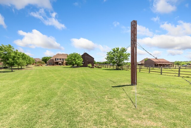 view of yard with a barn and fence