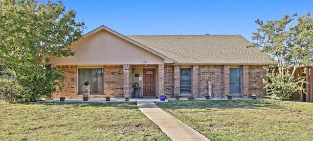 2609 Kimberly Dr, Garland, TX 75040 - ranch-style house featuring brick siding, a shingled roof, fence, and a front yard