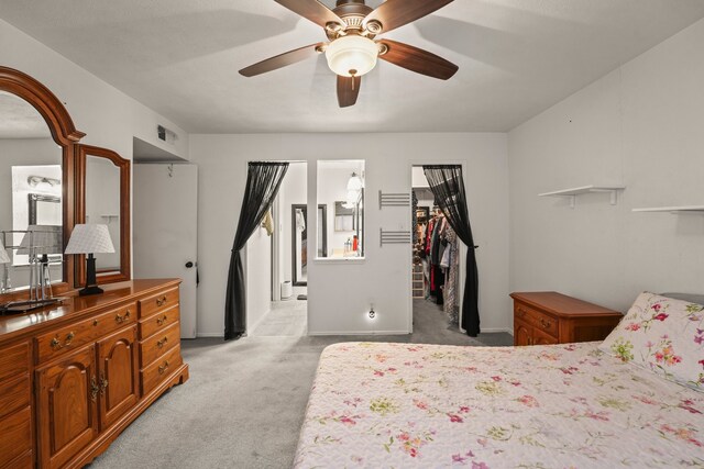 2609 Kimberly Dr, Garland, TX 75040 - bedroom with a walk in closet, a ceiling fan, baseboards, a closet, and light carpet