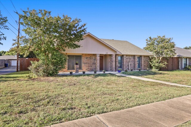 2609 Kimberly Dr, Garland, TX 75040 - ranch-style home with brick siding, fence, and a front yard