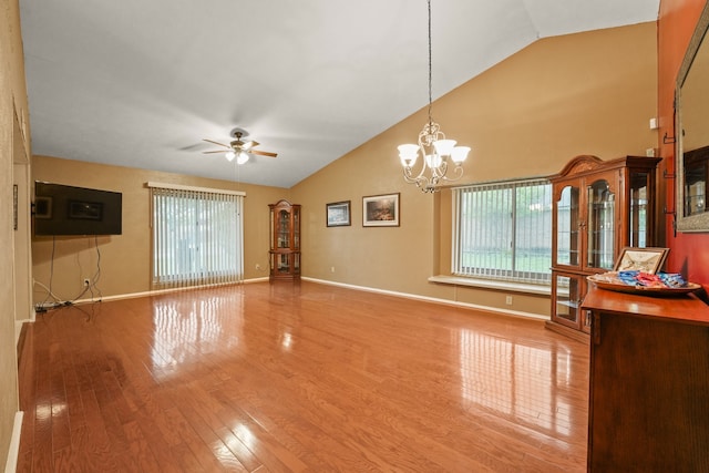2609 Kimberly Dr, Garland, TX 75040 - unfurnished living room with baseboards, ceiling fan with notable chandelier, high vaulted ceiling, and wood finished floors