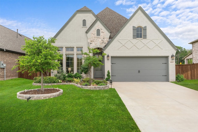 view of front of house with driveway, a front yard, a garage, brick siding, and fence