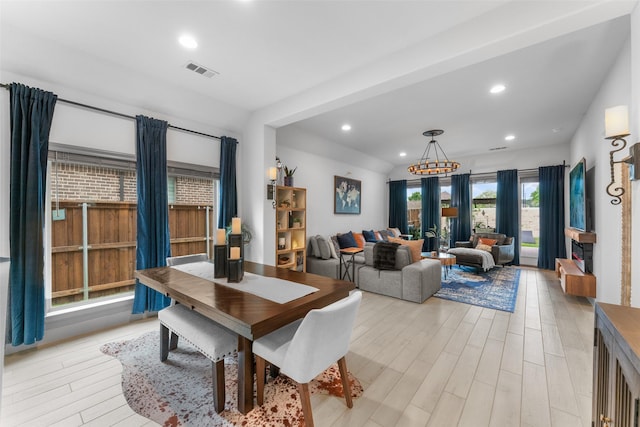 dining space featuring recessed lighting, a notable chandelier, light wood finished floors, and visible vents