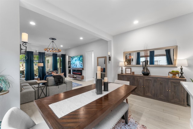 dining space featuring light wood-type flooring, recessed lighting, and an inviting chandelier