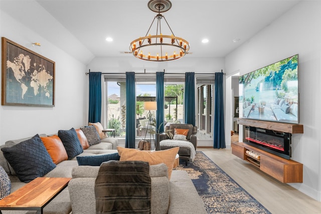 living area with an inviting chandelier, recessed lighting, light wood-type flooring, and lofted ceiling