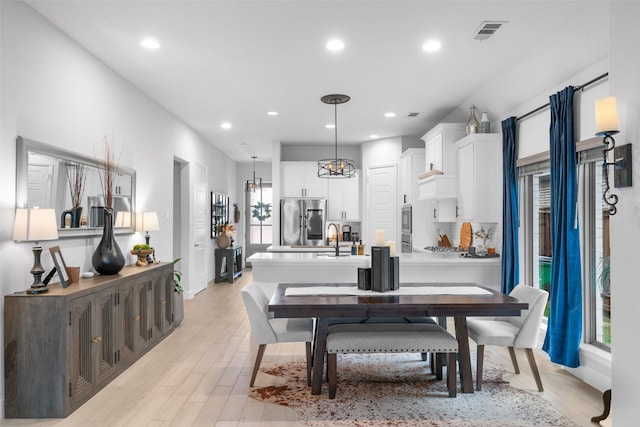 dining room featuring recessed lighting, visible vents, and light wood-style flooring