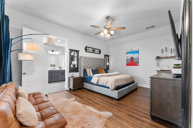 bedroom featuring visible vents, wood finished floors, baseboards, connected bathroom, and a ceiling fan