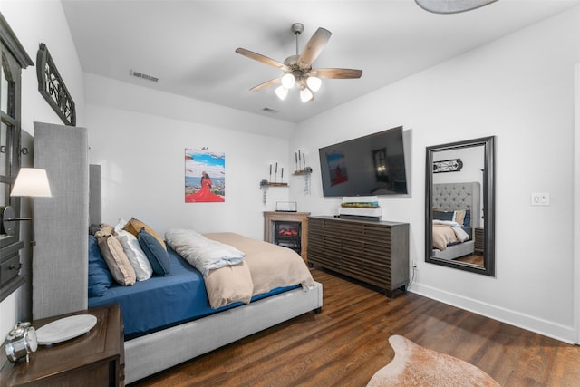 bedroom with visible vents, baseboards, ceiling fan, and wood finished floors