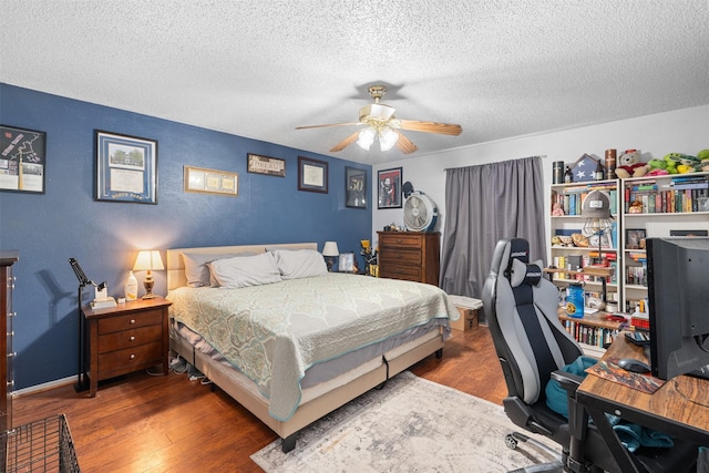 4212 Selina Ct, Arlington, TX 76016 - bedroom with wood finished floors, a desk, a textured ceiling, ceiling fan, and baseboards